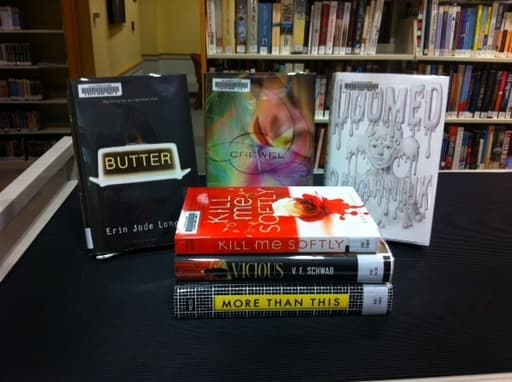 Books in a library, between them is Doomed Books in a library, between them is