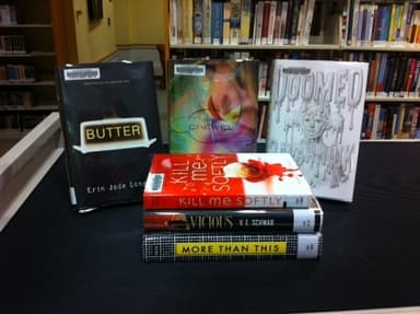 Books in a library, between them is Doomed Books in a library, between them is