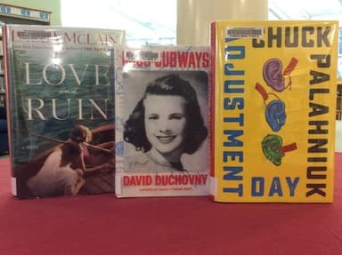 Books in library, one of them is Adjustment Day Books in library, one of them is