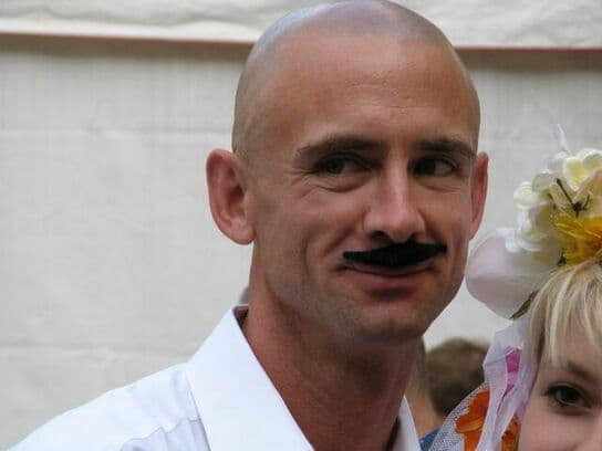 Chuck palahniuk with a moustache smiling Chuck palahniuk with a moustache smiling